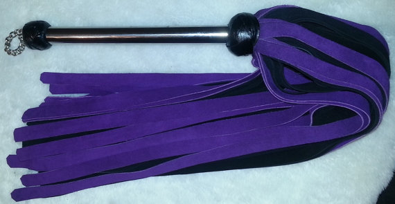 A purple suede flogger